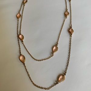 Long gold necklace with pale pink jewels
